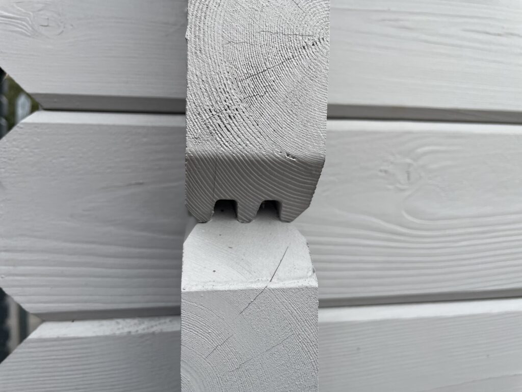 Close-up of a Tiger 44mm interlocking log with double tongue-and-groove joint.