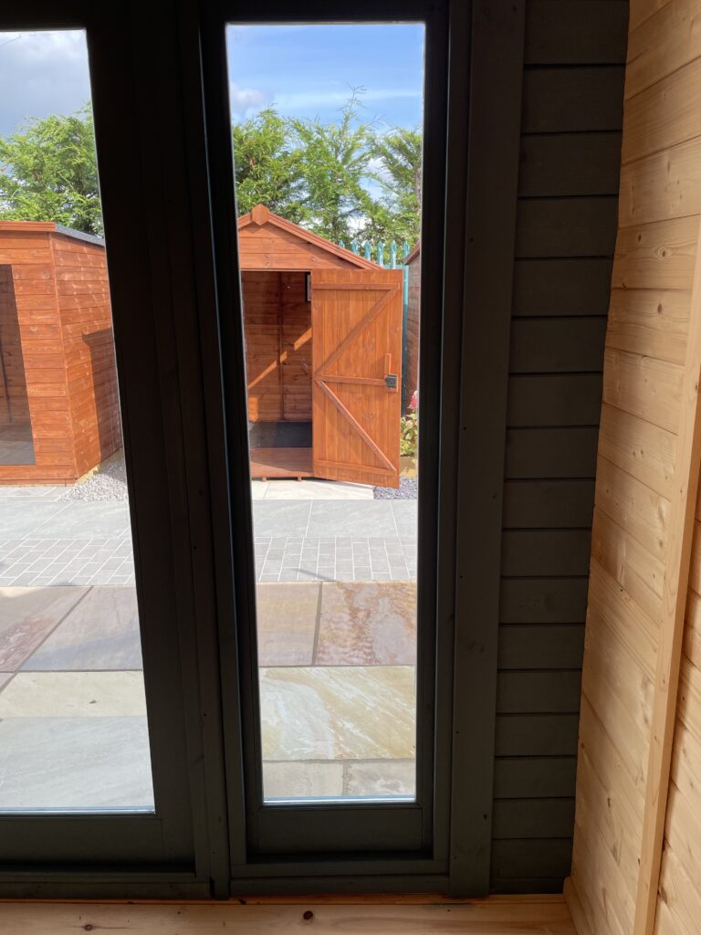 Interior view through glazed double doors of Tiger Aura 44 mm Log Cabin at Tong show site.
