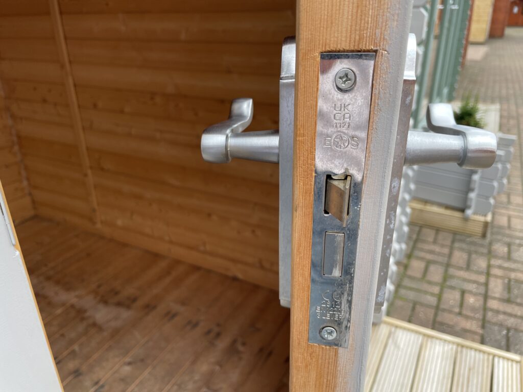 Close-up of Tiger Rho 44 mm Log Cabin stainless steel door handle and lock detail at Horsforth show site.