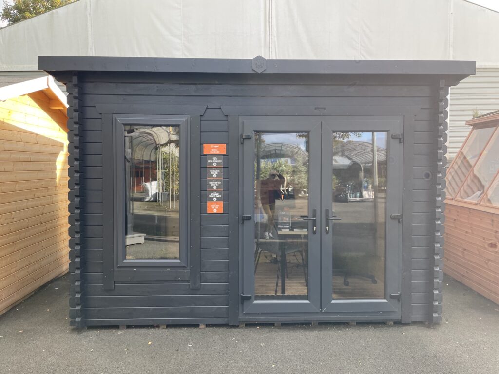 Close-up of Tiger Serena 44 mm Log Cabin anthracite uPVC double doors with black handles and locking mechanism at Otley show site.