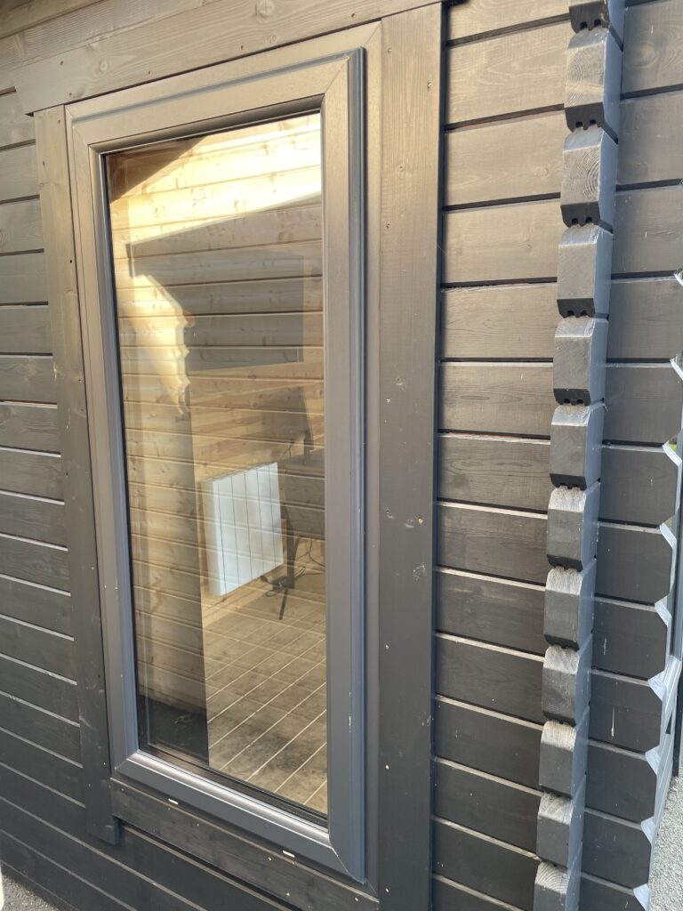 Close-up of Tiger Serena 44 mm Log Cabin anthracite uPVC window frame with double glazing at Otley show site.