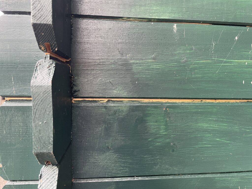 Corner joints of a green wooden garden building