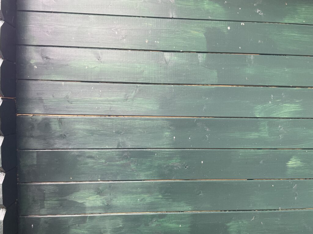 Green wooden corner joints of a garden building