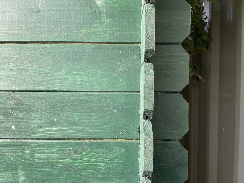 Close-up of timber corner joints in green finish