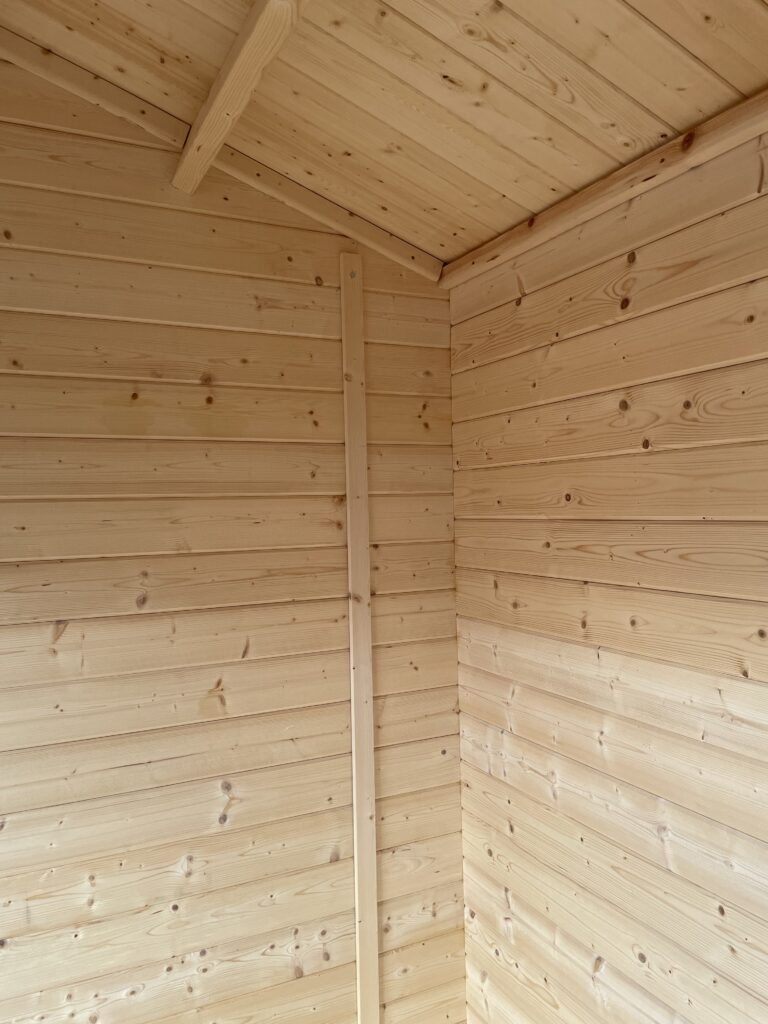 Interior view of an apex roof featuring smooth wooden panels