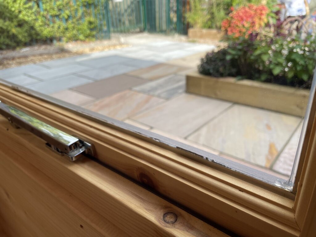 Close-up of a full-pane window frame with a metallic handle