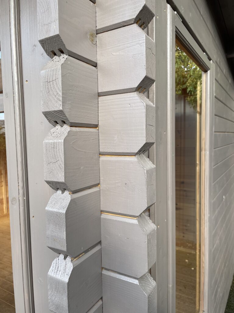 Close-up of grey corner joints in a garden building