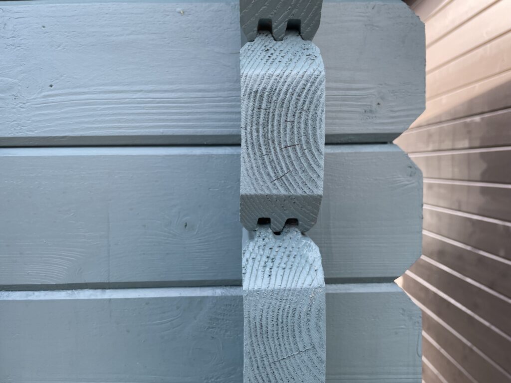 Grey corner joints of a garden building with visible wood grain