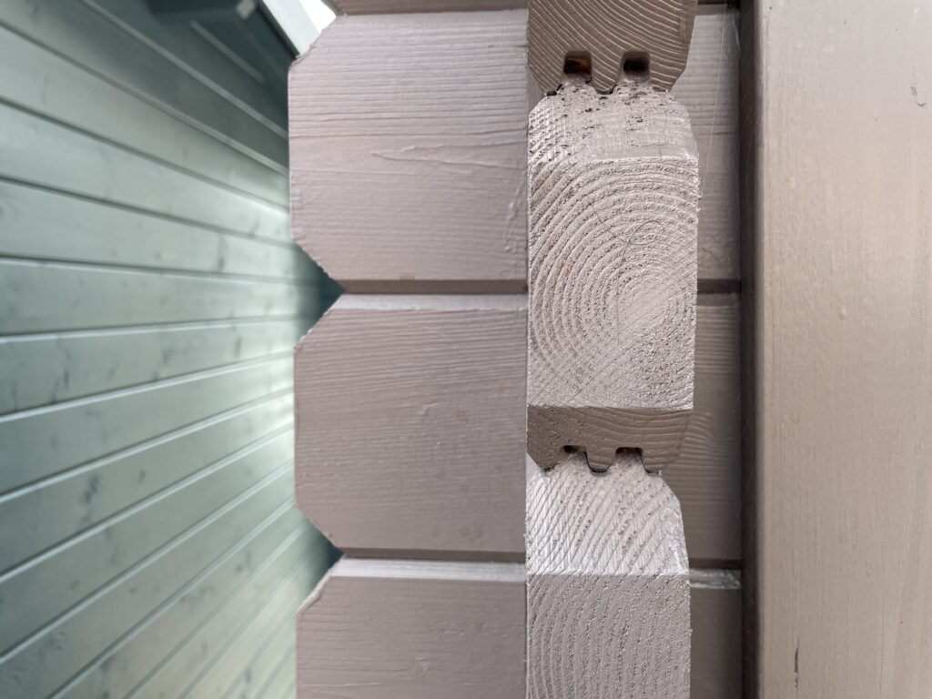 Close-up of grey corner joints in a log cabin
