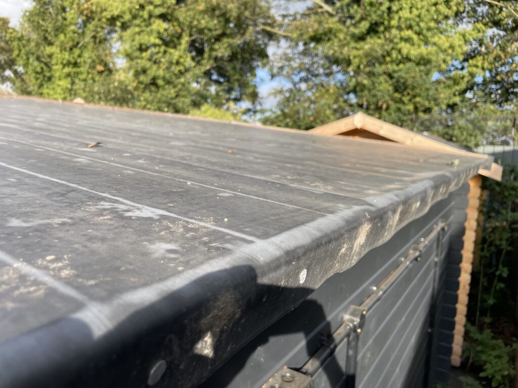Pent roof with black finish on a garden building