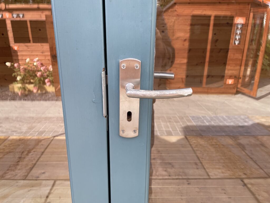 Close-up of a blue timber door handle