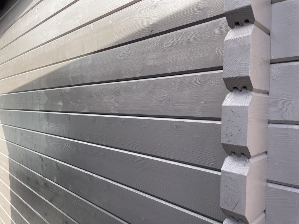 Corner joints of grey timber cladding showcasing craftsmanship