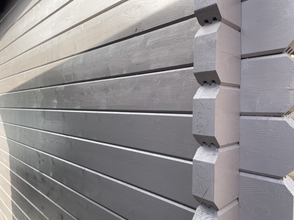 Close-up of grey timber corner joints on a garden building