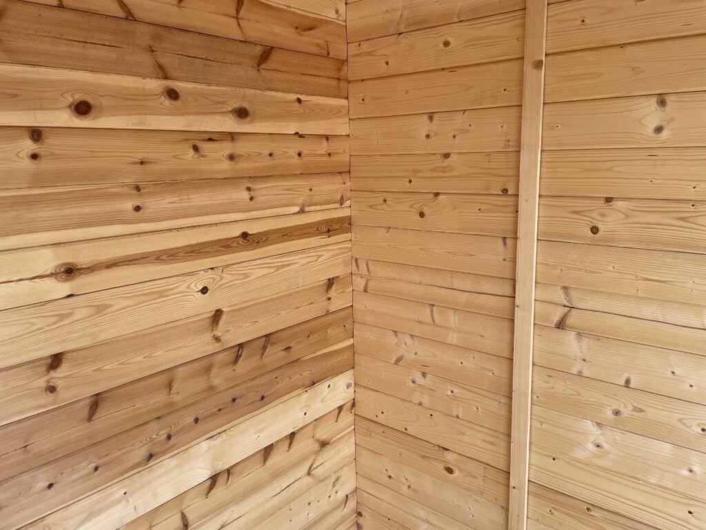 Interior view of timber cladding with natural knots and grain patterns
