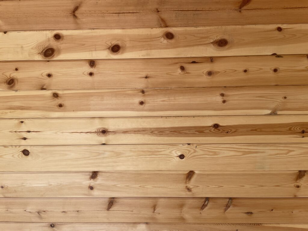 Interior timber wall cladding with visible knots and grain patterns