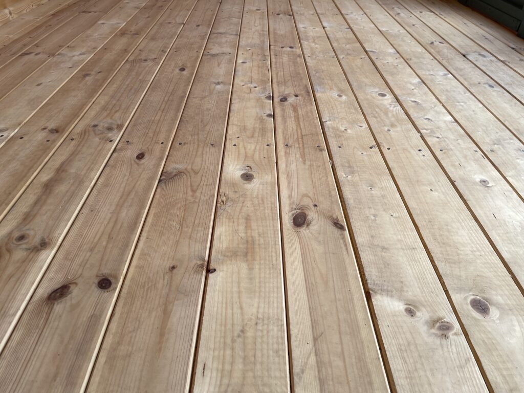 Timber floorboards showcasing natural knots and grain patterns