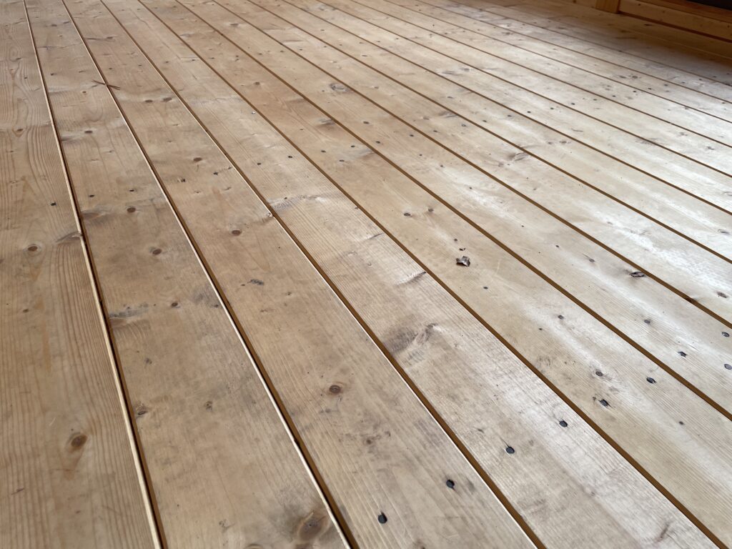 Timber floorboards showcasing natural knots and grains