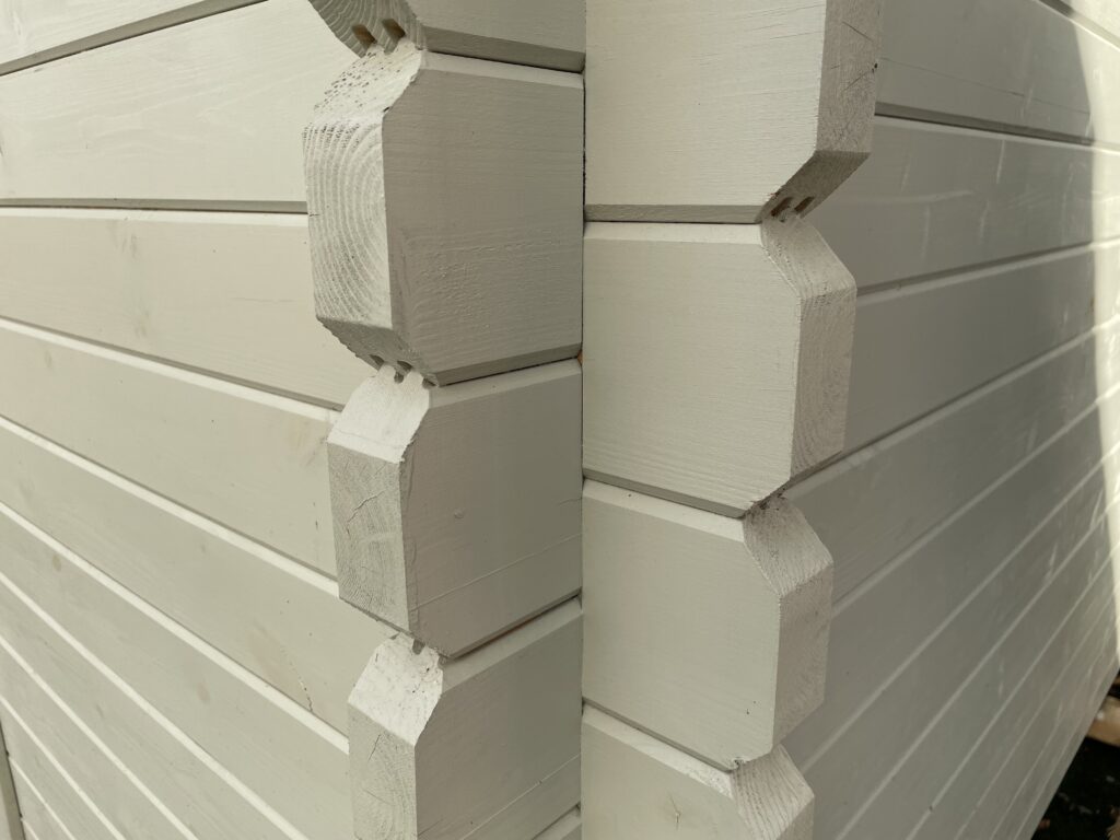 Close-up of white corner joints in a wooden garden building