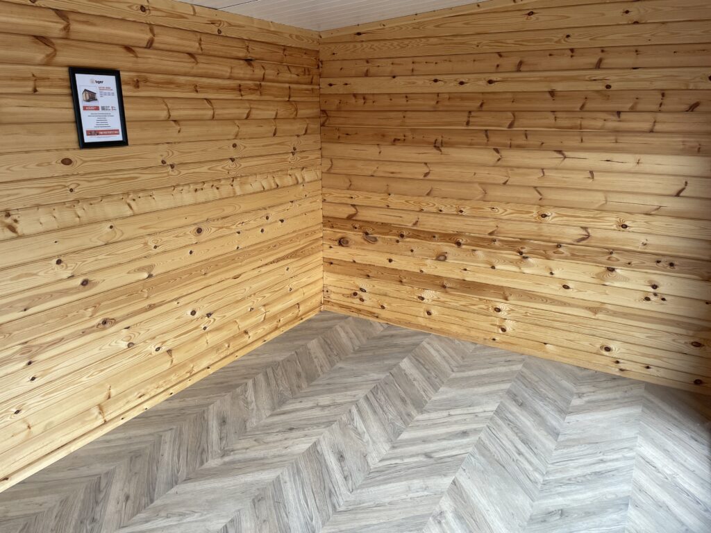 Interior view showcasing timber walls and a herringbone floor pattern