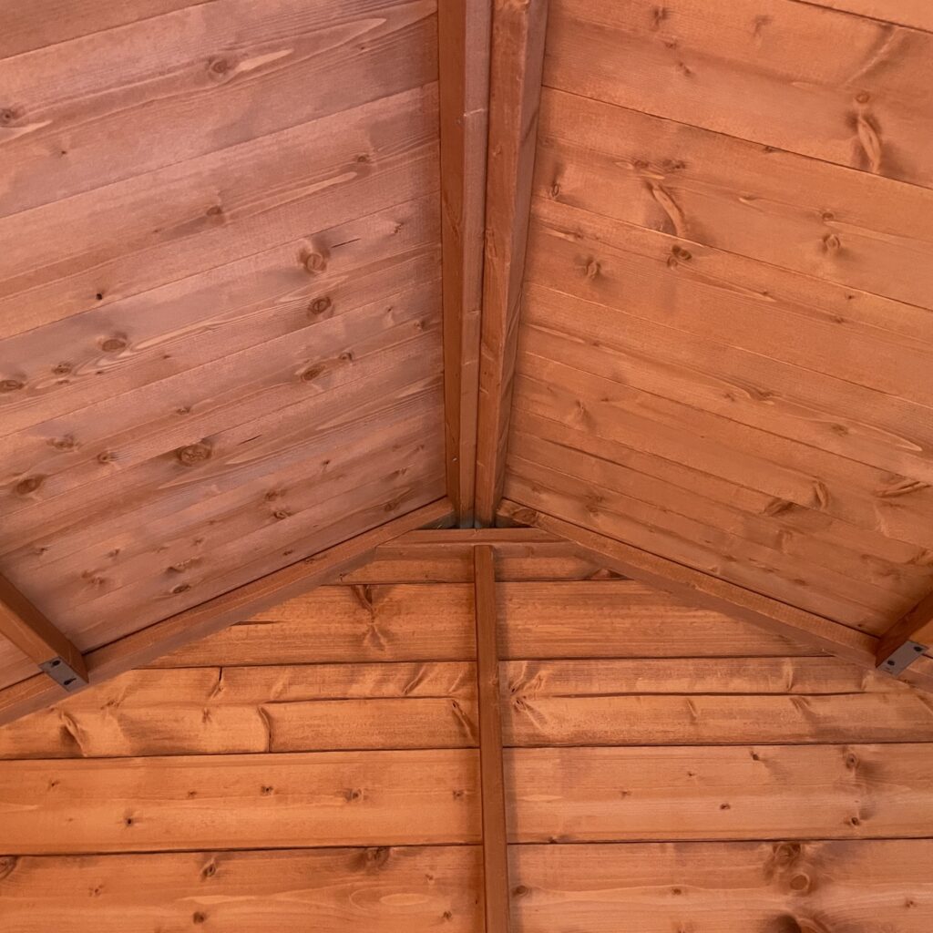 Interior view of a wooden apex roof structure with timber beams