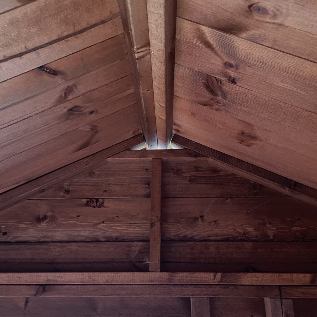 Interior view showcasing the apex roof structure of a garden building