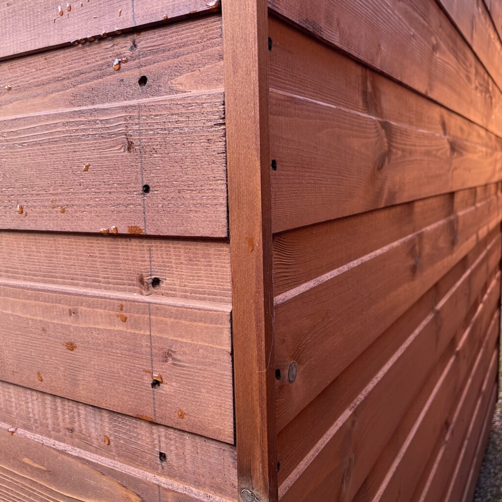 Detailed view of overlapping cladding on a garden building