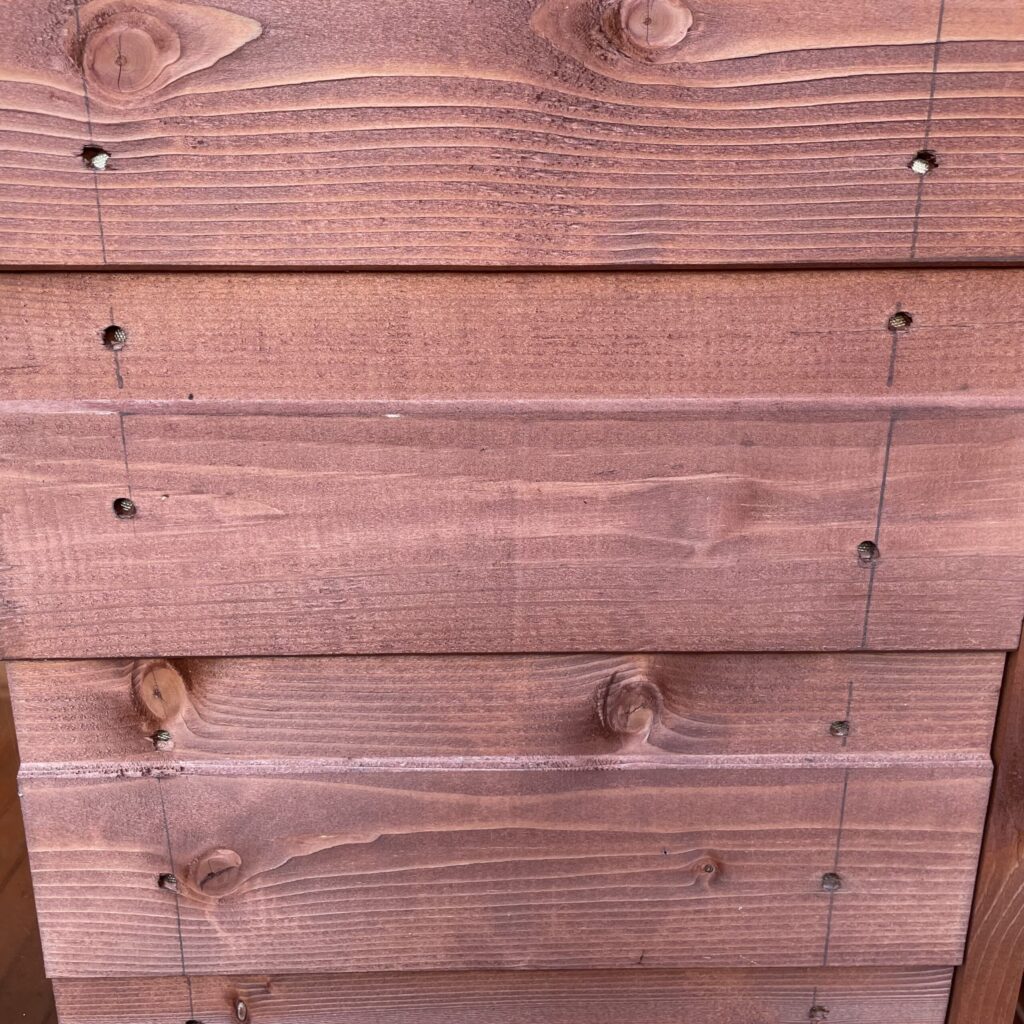 Detailed view of overlapping wooden cladding from a garden building