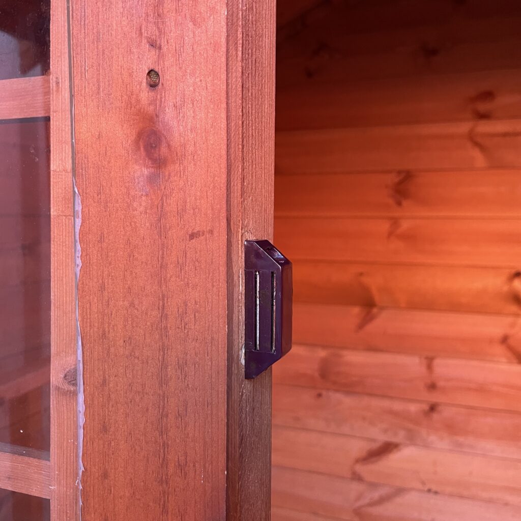 Close-up of the magnetic safety catch on a Tiger playhouse door