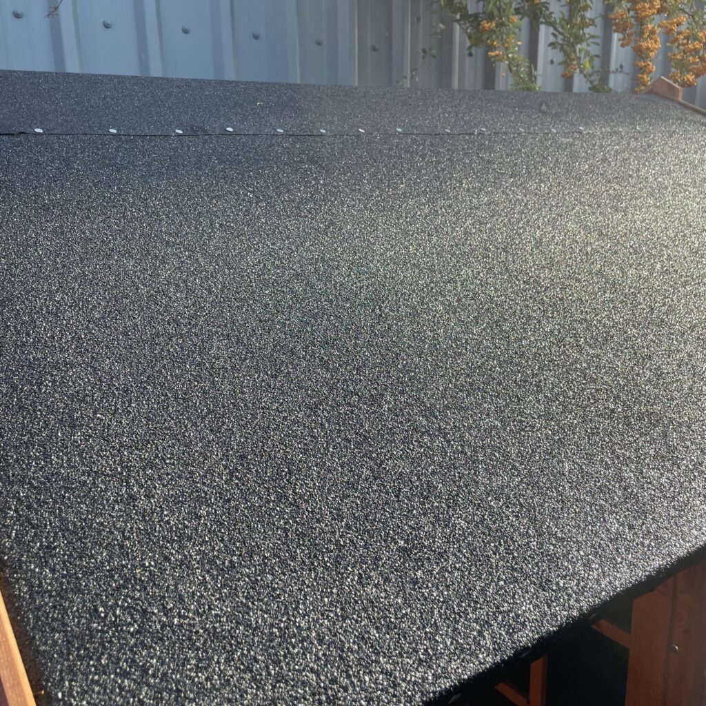 Close-up of heavy-duty black mineral felt on a Tiger playhouse roof