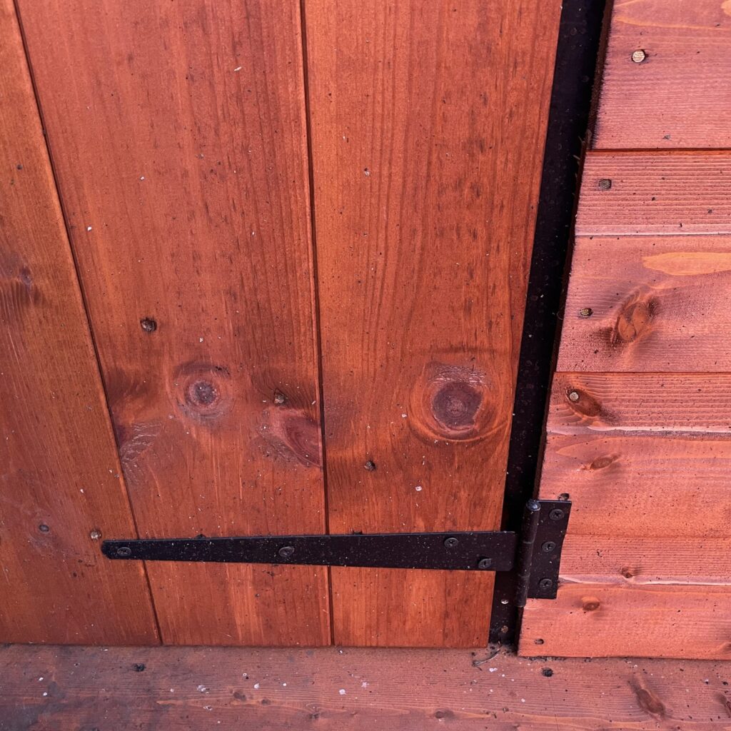 Close-up of a sturdy hinge on a Tiger playhouse door