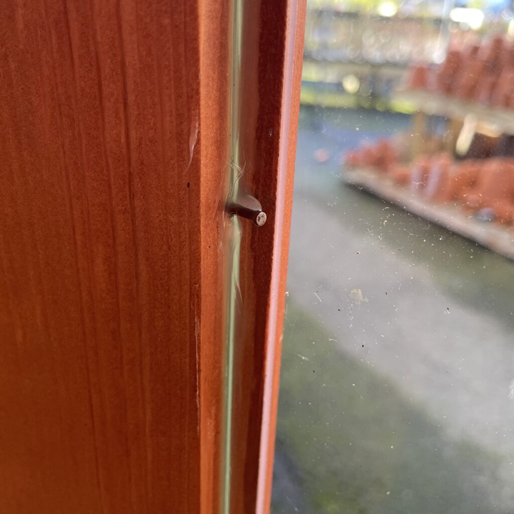 Close-up of a corner joint in a summerhouse showing a nail
