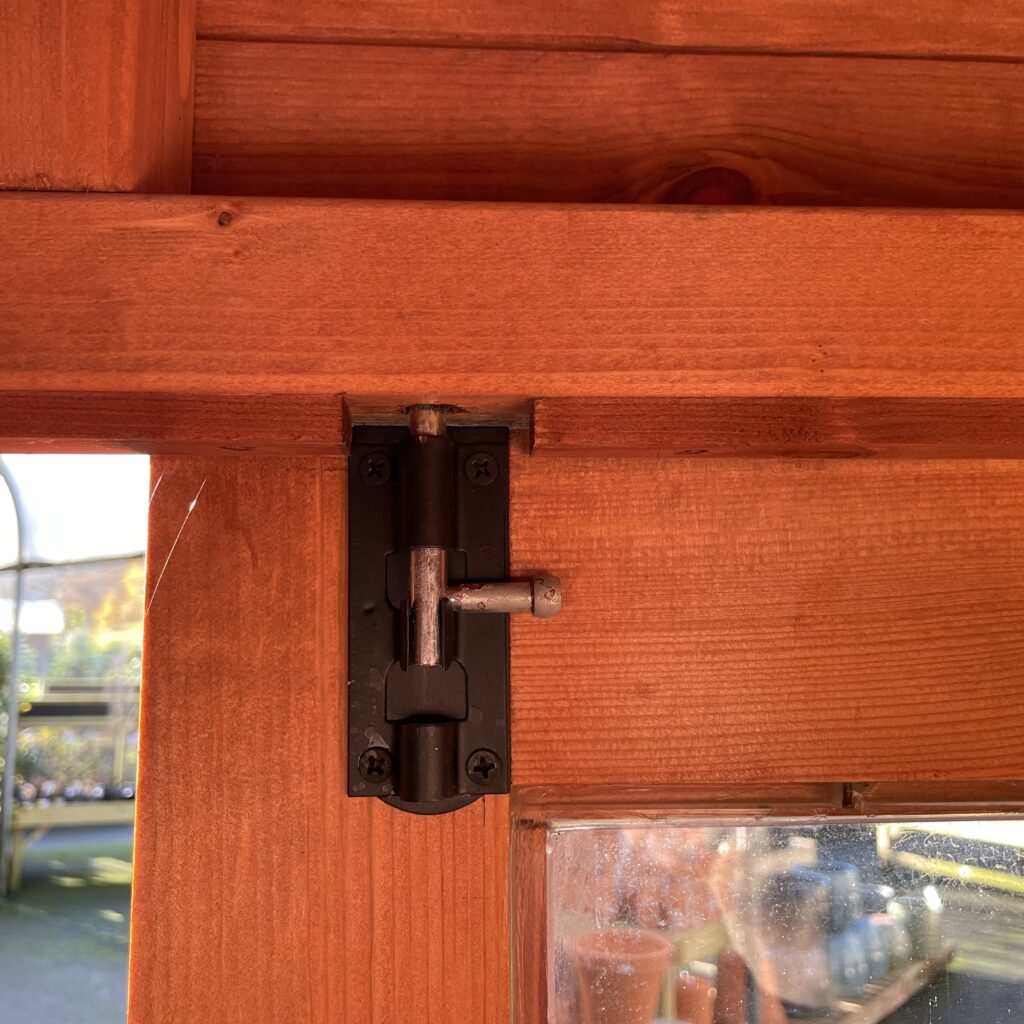 Close-up of a corner joint hinge in a summerhouse