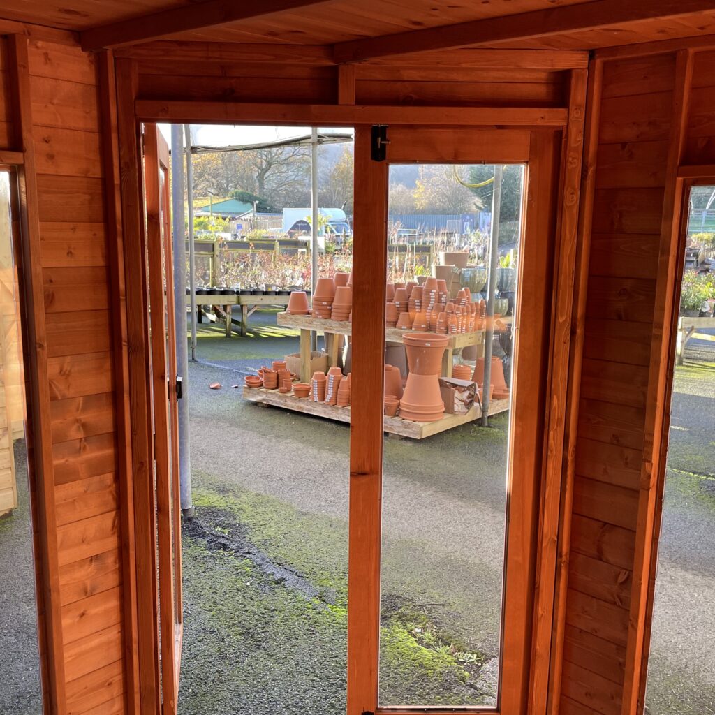 Interior view of the Tiger Corner Summerhouse with double doors and wooden cladding