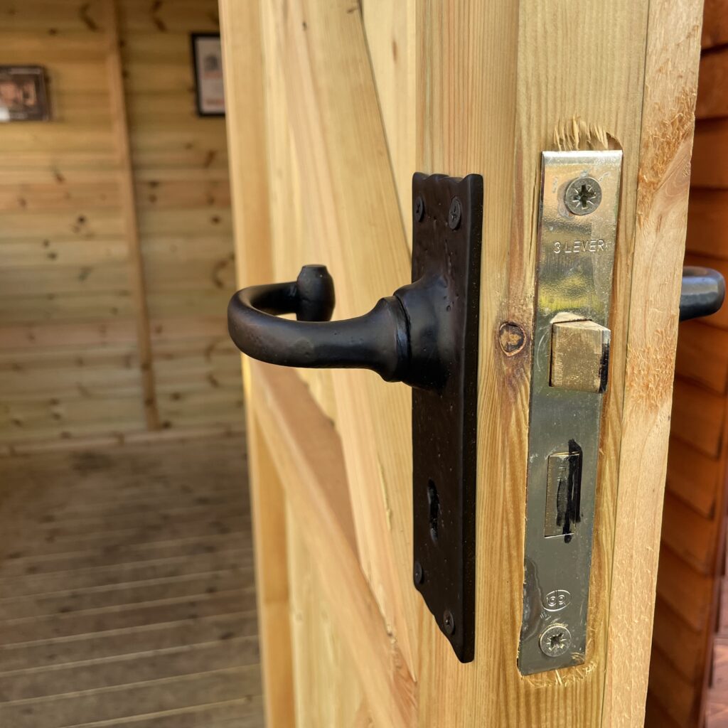 Close-up of the door handle and lock on a Tiger Elite Apex Shed