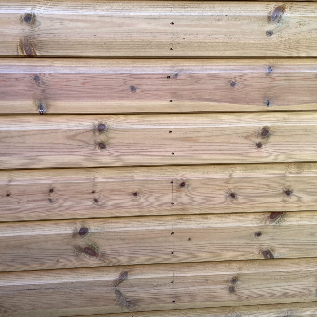 Close-up of the wooden cladding showing natural grain and joinery