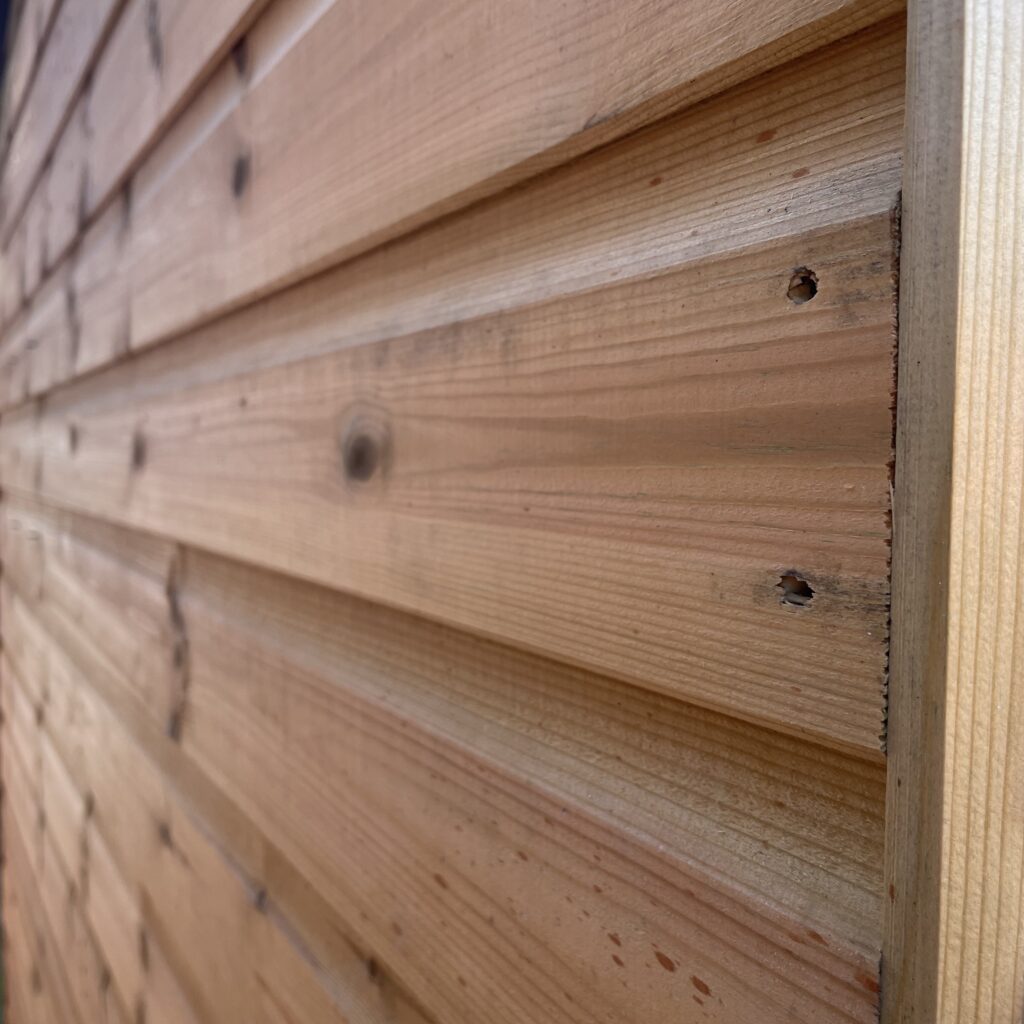 Close-up of the wooden cladding on a Tiger Elite Apex Shed
