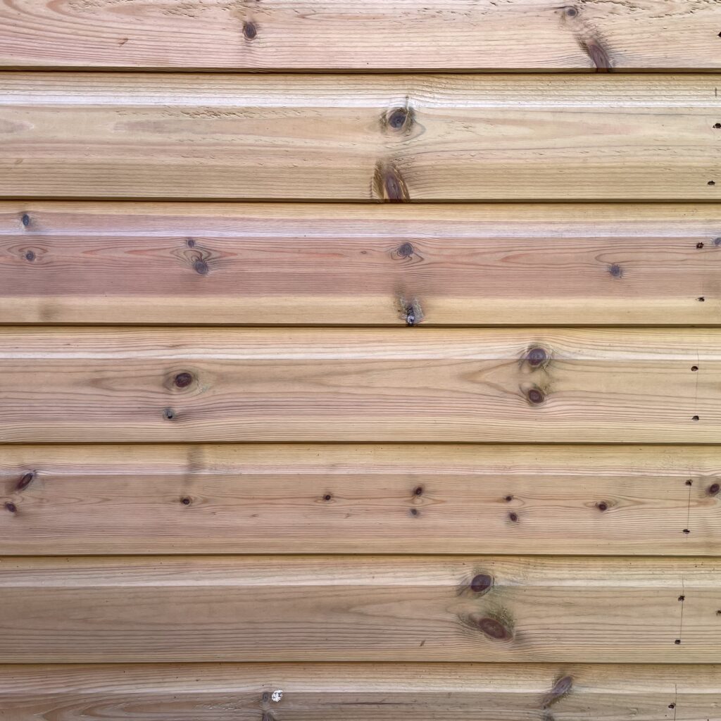 Close-up of the wooden cladding on the Tiger Elite Pressure Treated Apex Shed