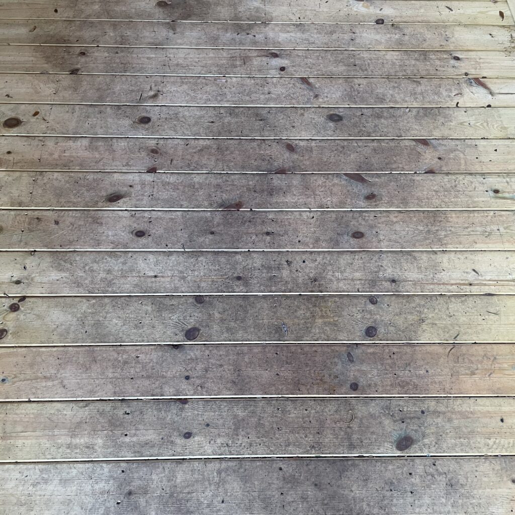 Wooden flooring of a garden shed with visible grain and texture