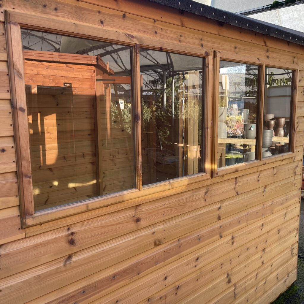 Side view of the Tiger Elite Pressure Treated Apex Shed showcasing large windows and wooden cladding