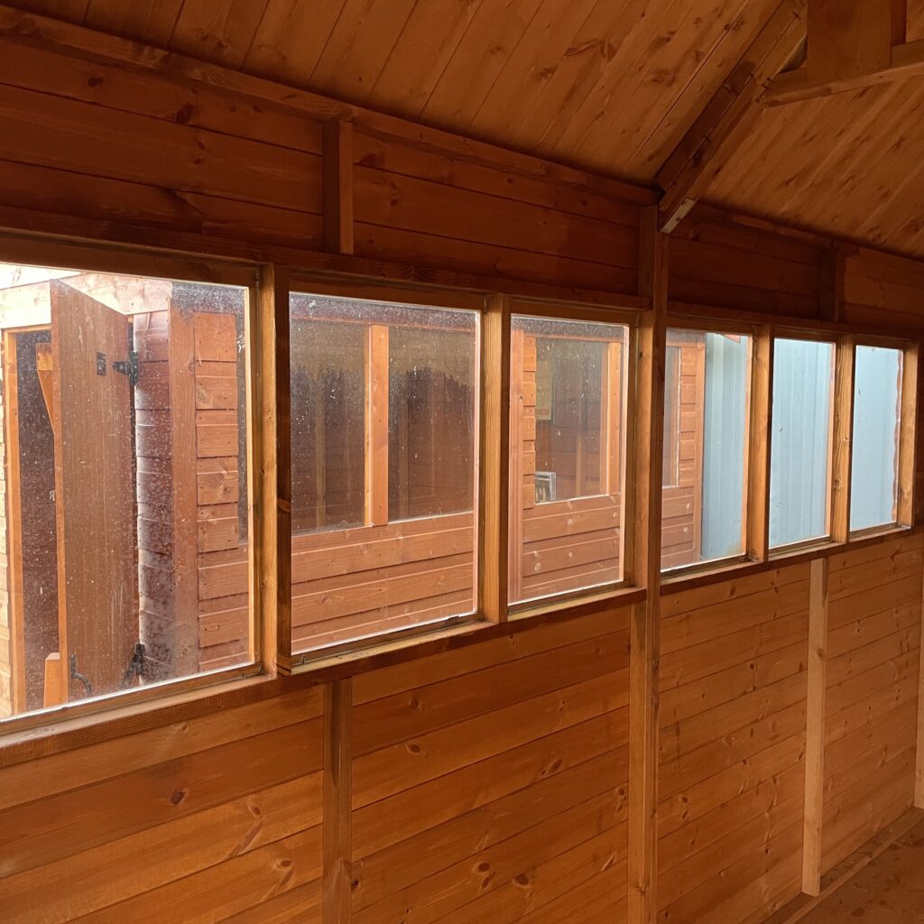 Interior view showcasing multiple windows in a garden building
