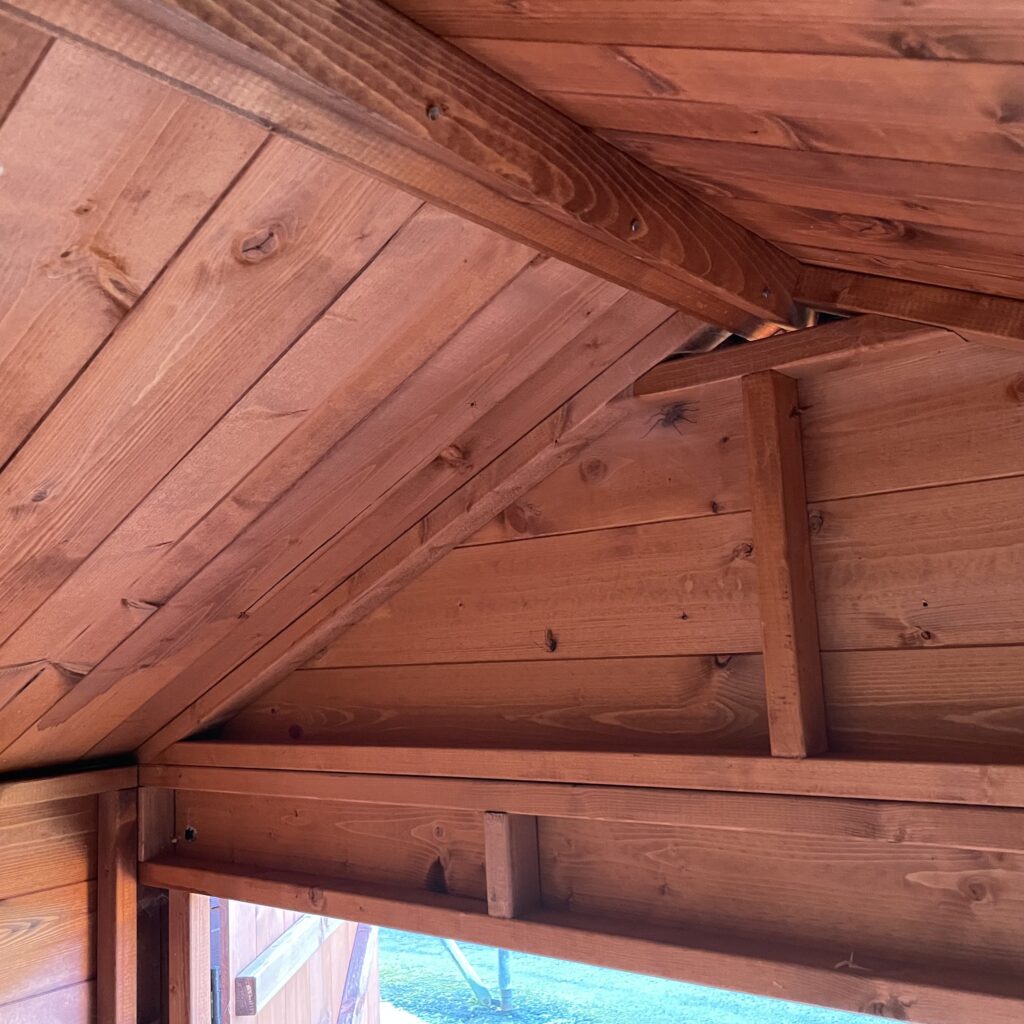 Interior of a log cabin with wooden beams and cladding