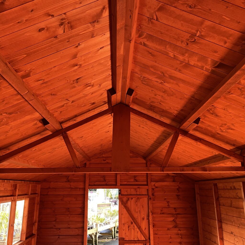 Interior view showcasing the wooden beams and cladding of a log cabin