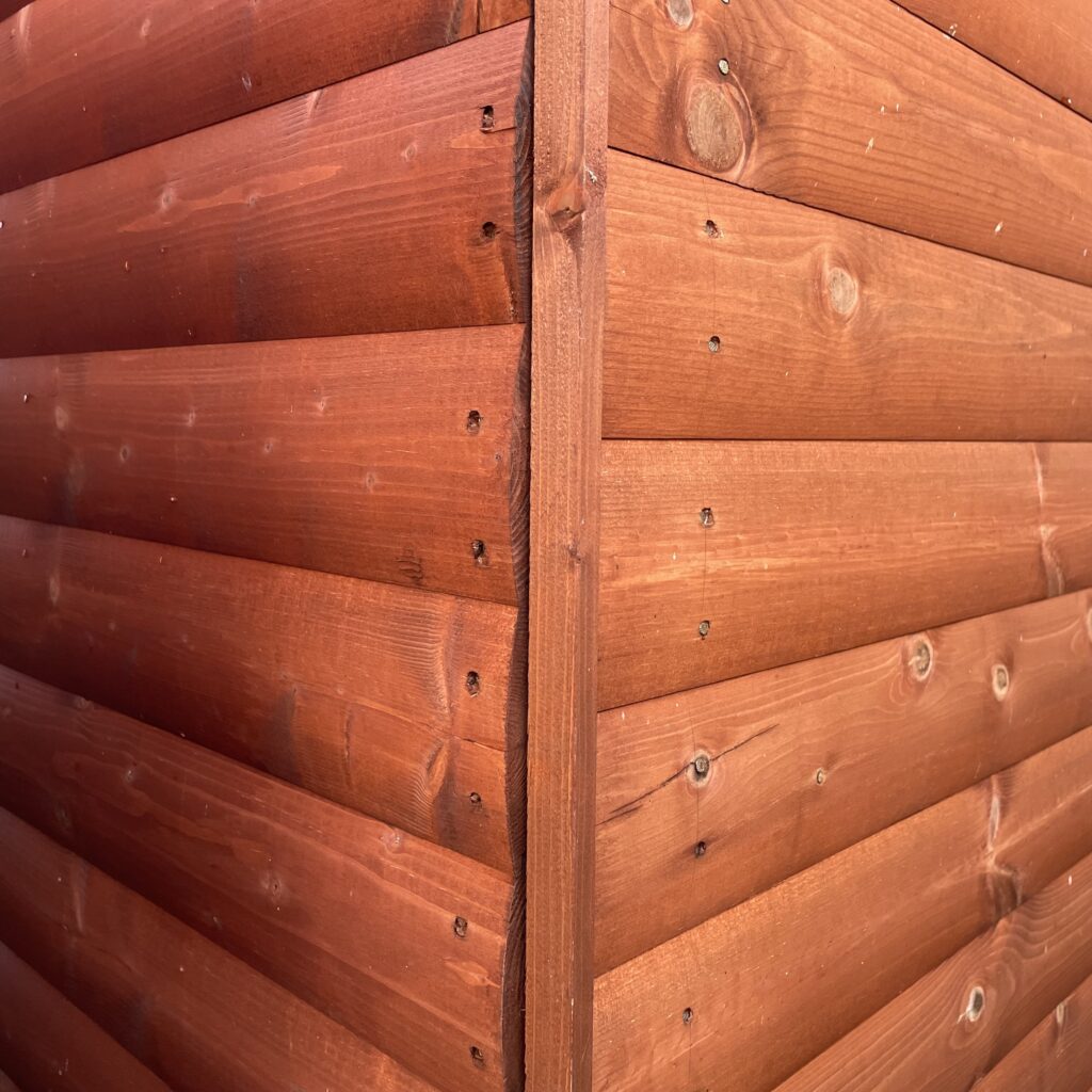 Close-up of the log lap cladding on a Tiger Loglap Mini-Barn