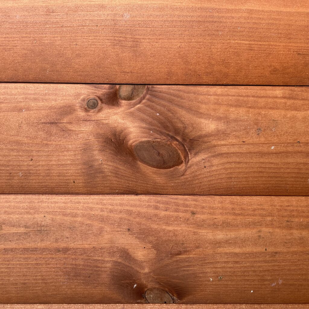 Close-up of Tiger Loglap Mini-Barn cladding showing natural wood grain and knots