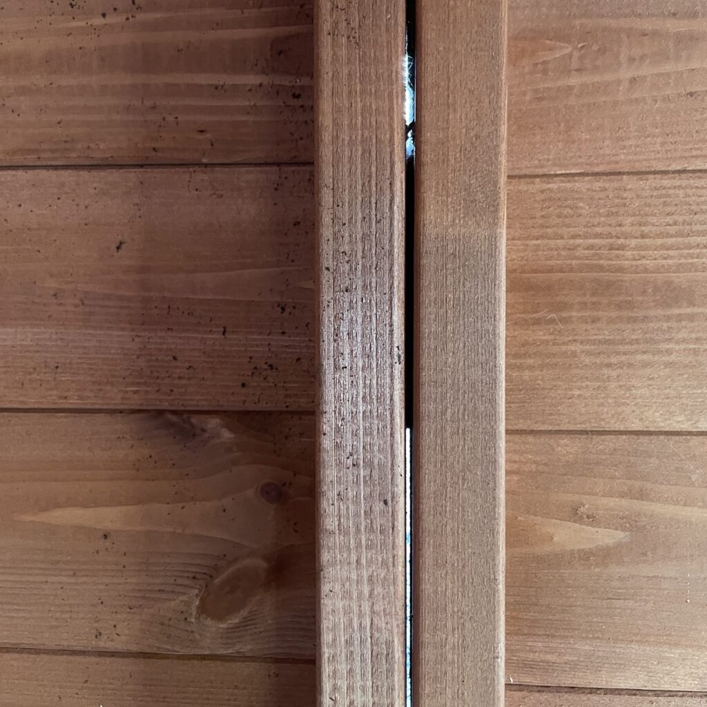 Close-up view of log lap cladding showing joinery details