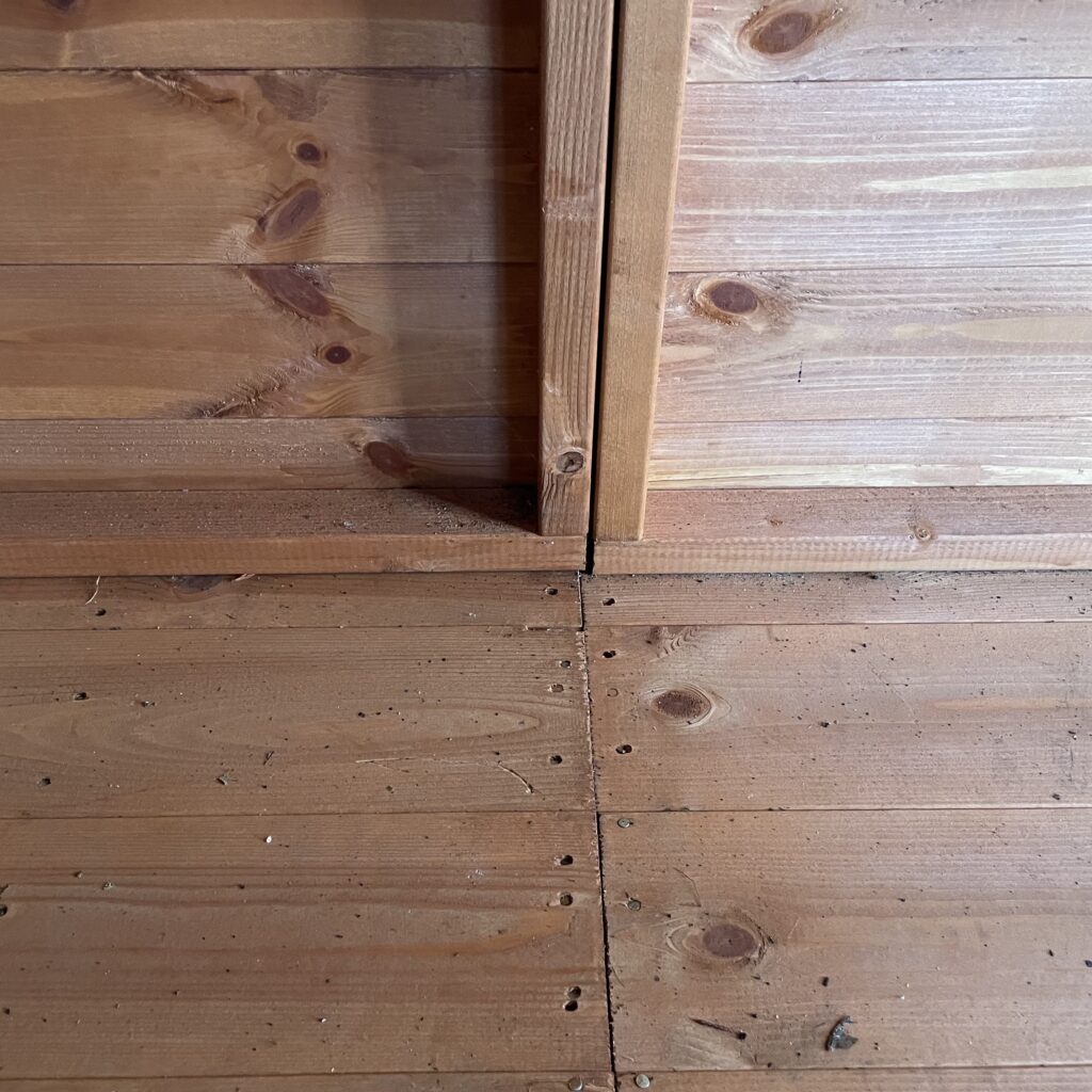 Close-up of the floor joinery in the Tiger Loglap Mini-Barn