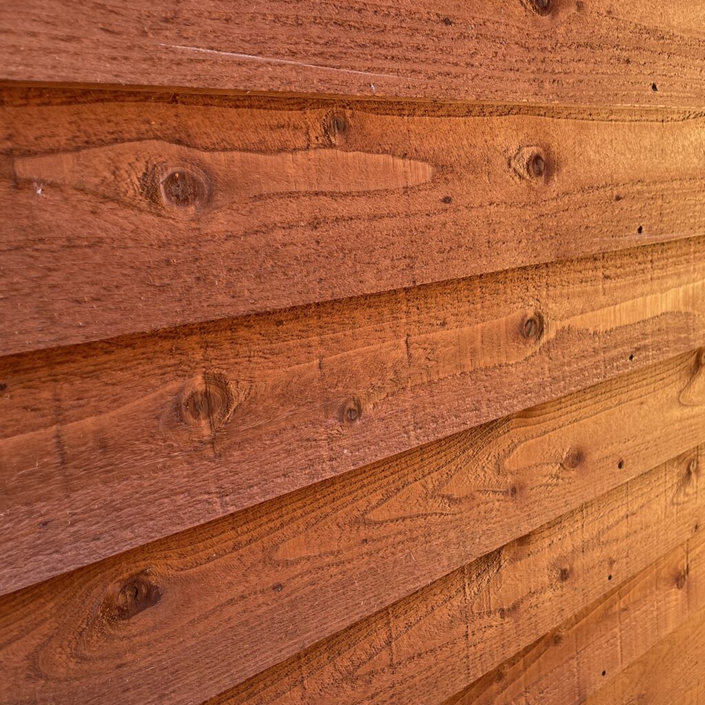 overlapping wooden cladding of a garden shed