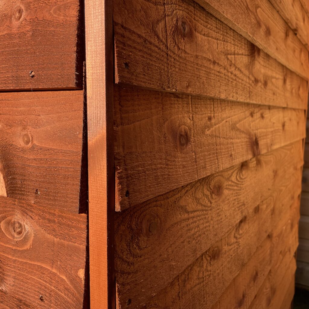 Close-up of overlapping wooden cladding on a shed