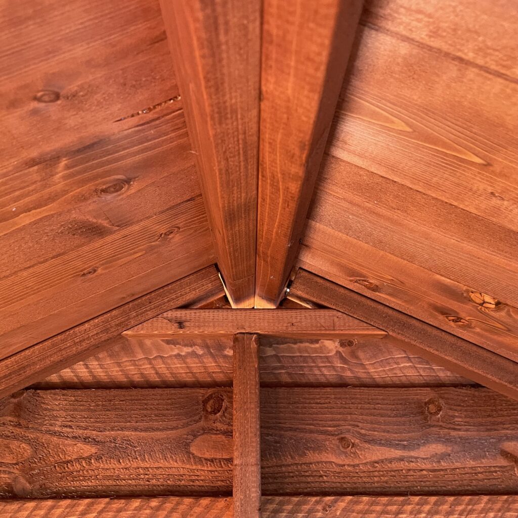 Interior view of an apex roof showcasing wooden beams and joinery