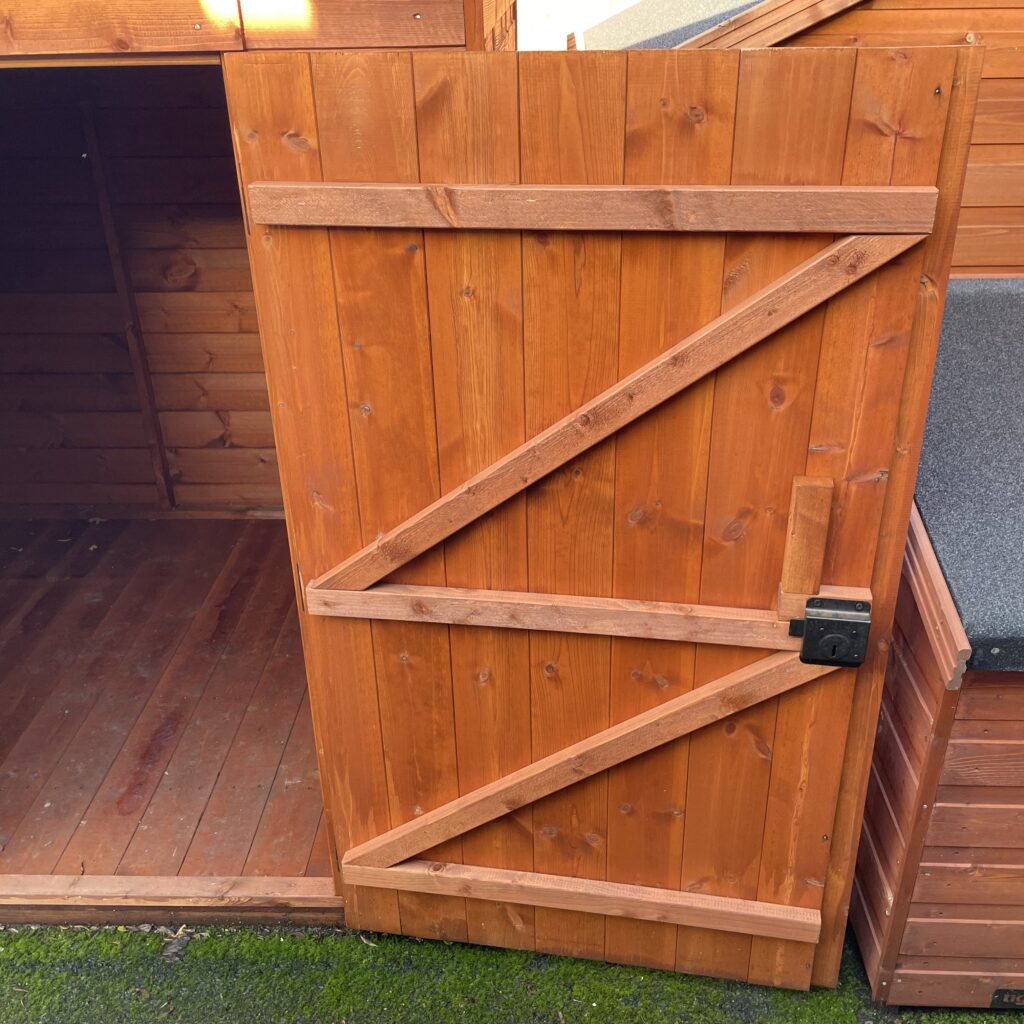 Sturdy wooden door of the Tiger Pent Bike Shed with a secure latch